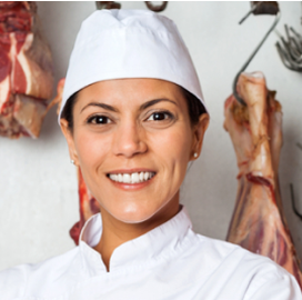 Female Jenkins butcher wearing safety cap smiling on a white background