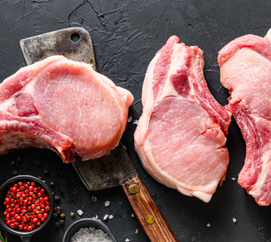 fresh cut pork on a black surface