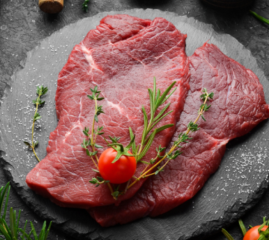 fresh cut veal on a black surface with 
